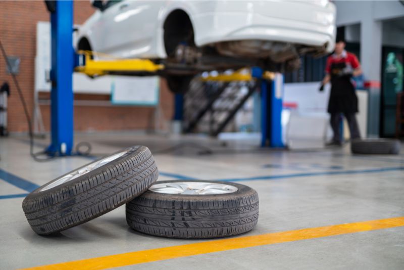 A garage epoxy floor with car tyres in view
